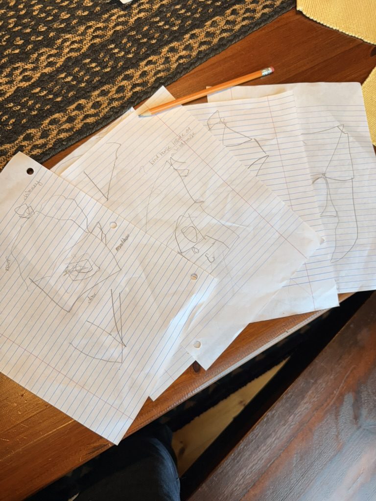 A spread of pencil drawings of birdhouse ideas on lined paper